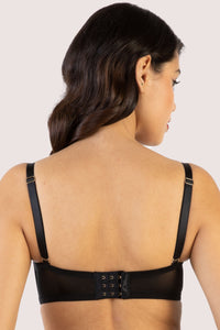 model shows the back of the Genevieve black pvc overwired with hook eye bra