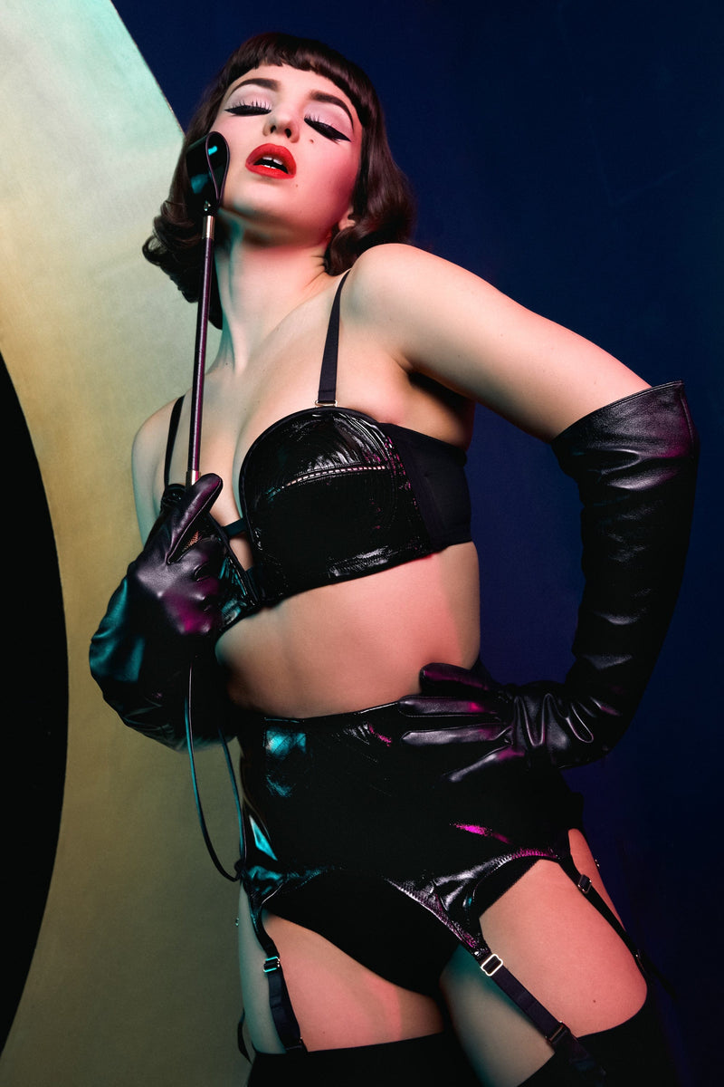 model wears Genevieve black pvc overwired bra and genevieve black suspender