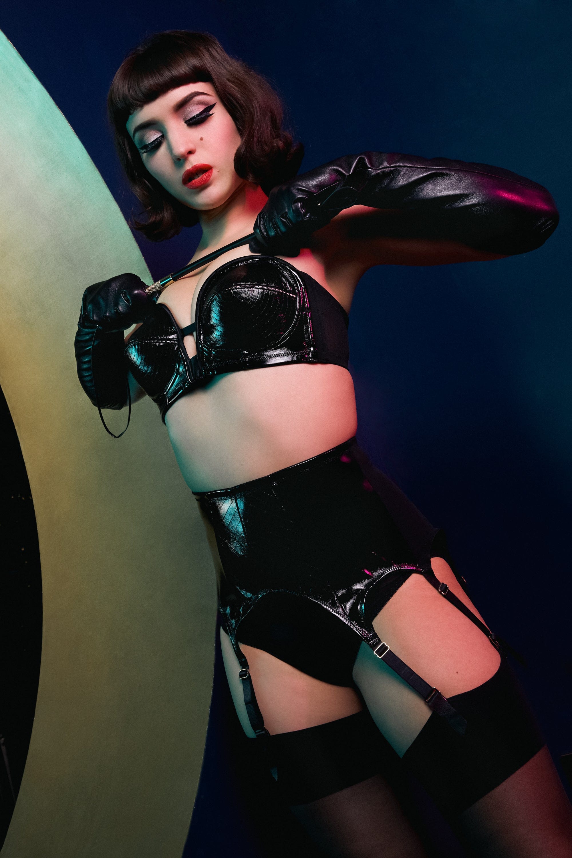 model wears Genevieve black pvc overwired bra and genevieve black suspender