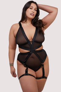 model wears black mesh elastic multi strap bodysuit