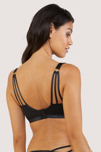 model shows us the back of the embroidered plunge black bra with straps and hook
