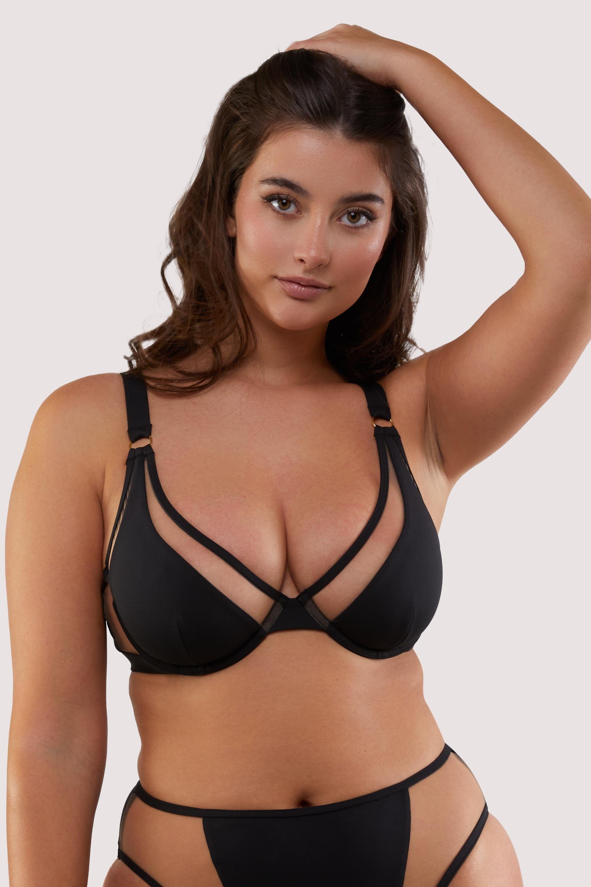 fuller bust model wears black and nude mesh sexy underwire bikini top with thick shoulder straps