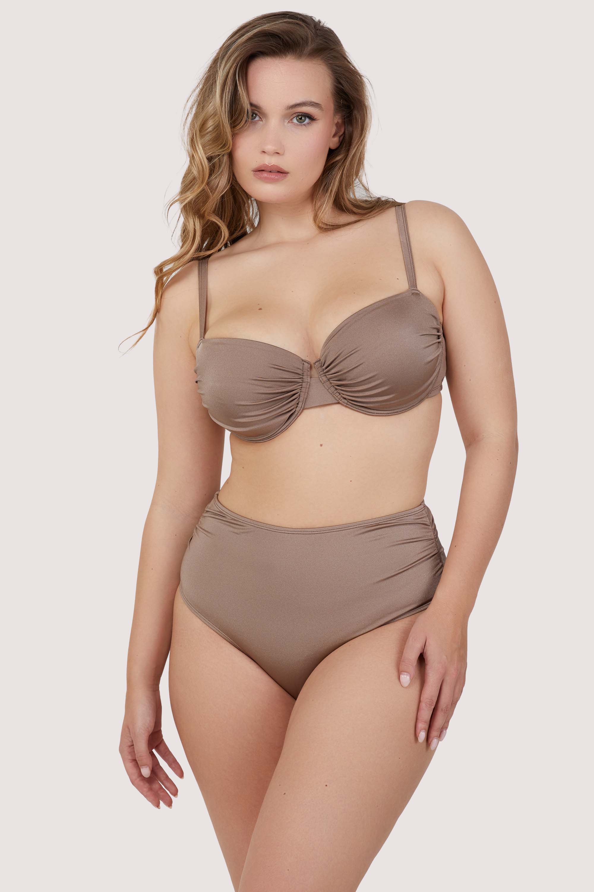 Model wears taupe underwire bikini and high-waist brief set