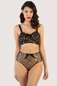 model wears Solar black and gold cosmic print bullet bra with high waisted solar black and gold brief