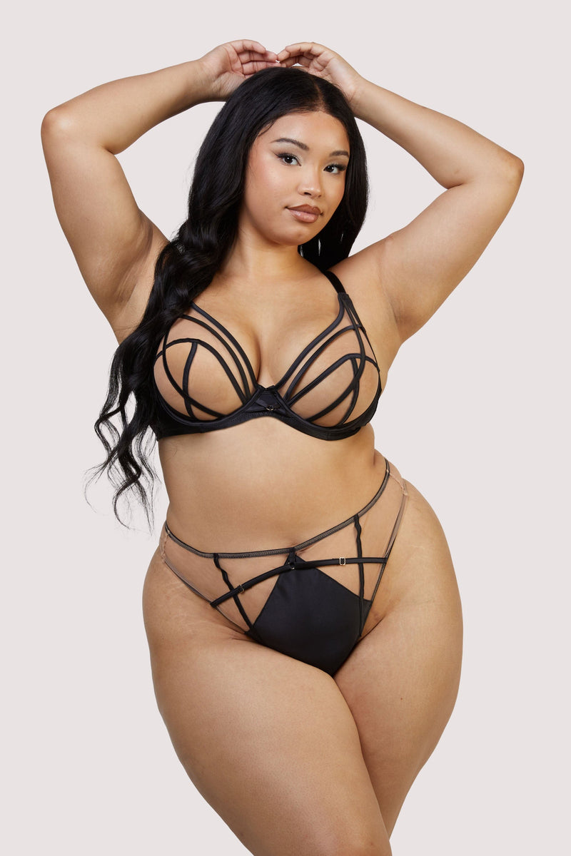 model wears black mesh bra and high waisted thong