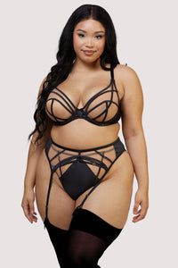 model wears the black mesh bra, high waisted thong and black mesh suspender