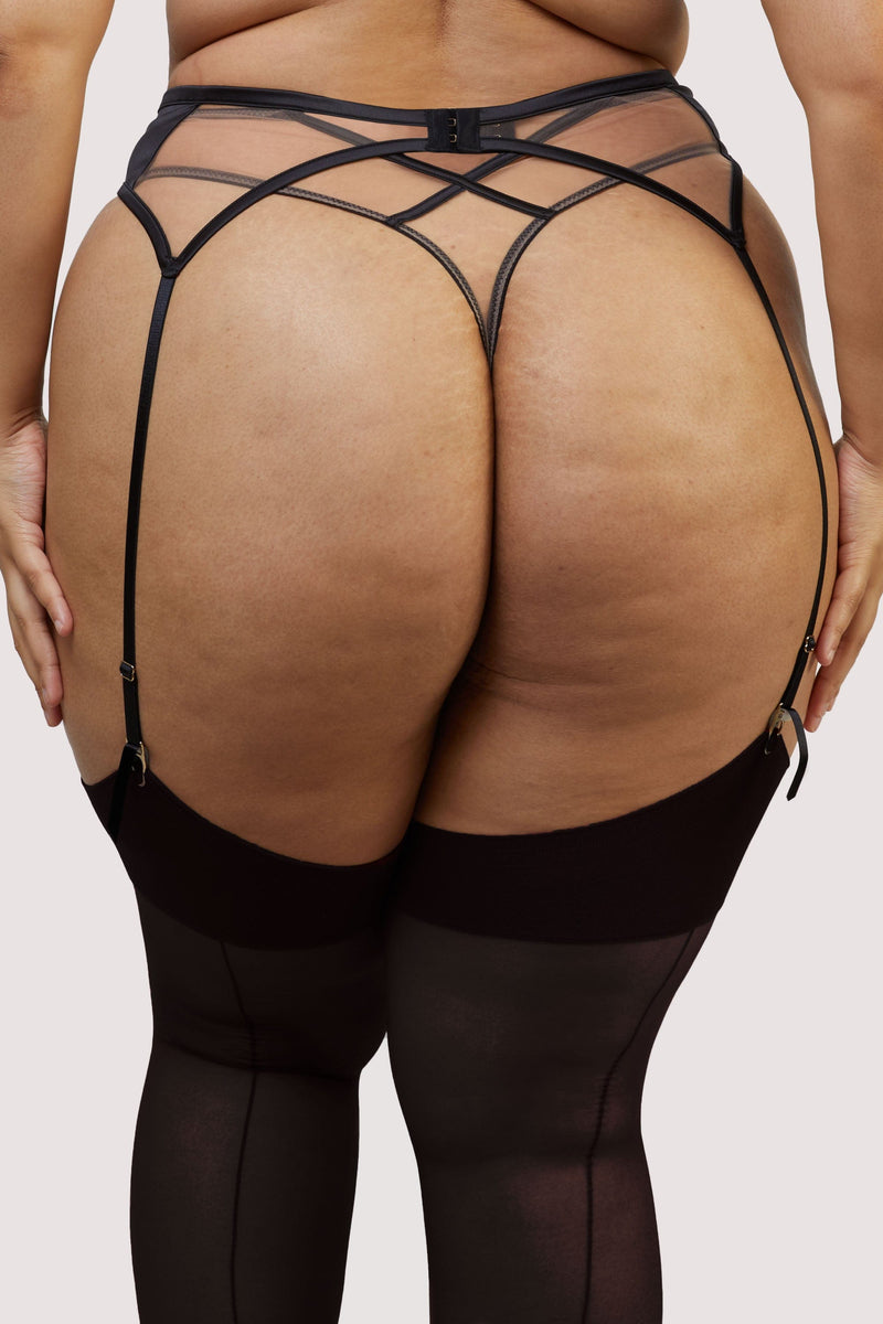 model shows the behind of the high waisted thong and black mesh suspender