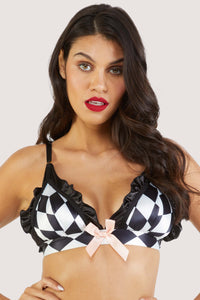 Harlequin print bra with black frill trim and pink bow in centre.