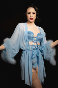 model wears sheer blue robe with feather hem