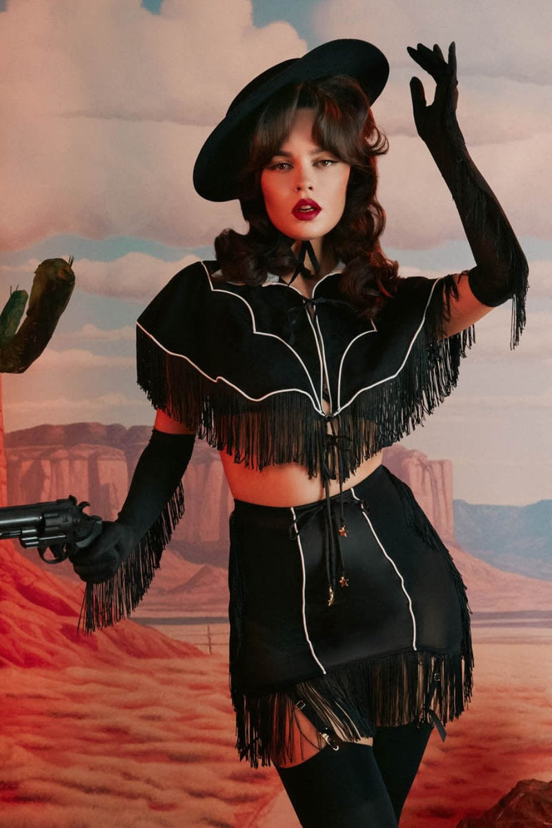 model wears Billie western cowboy fringe cape with Billie western cowboy fringe grindle with suspender