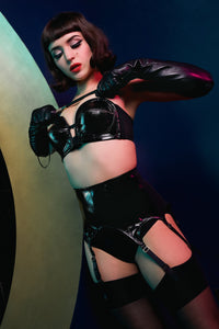 model wears Genevieve black Pvc bra with Genevieve black suspender belt