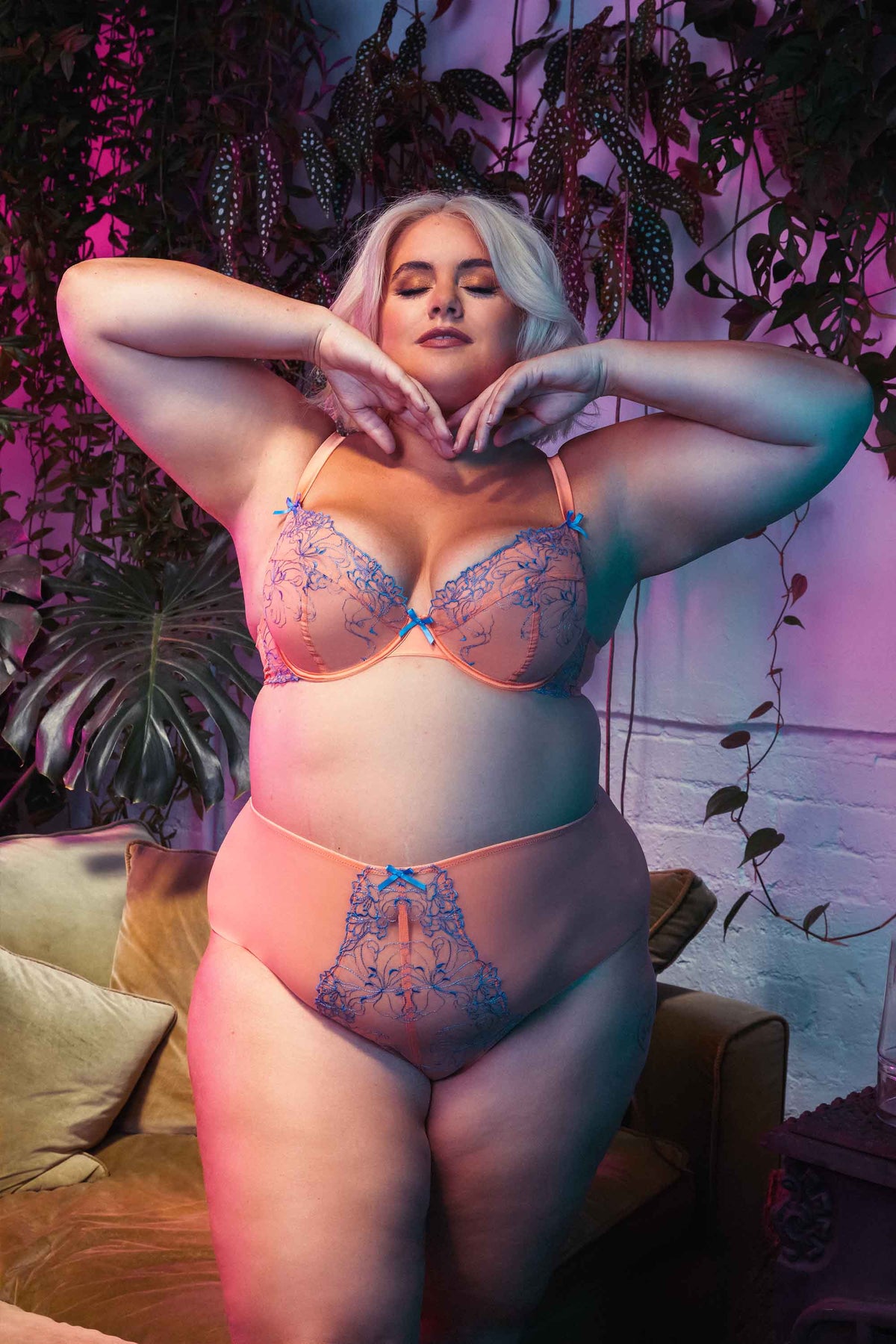 Orange mesh bra with blue-lilac embroidery and bows, worn with matching brief by Felicity Hayward.
