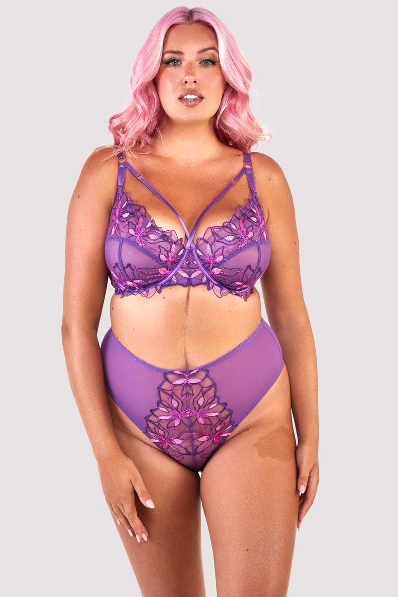Mesh purple bra embroidered with a pink and purple floral design, with satin caging over the bust, worn with a matching high waisted thong.