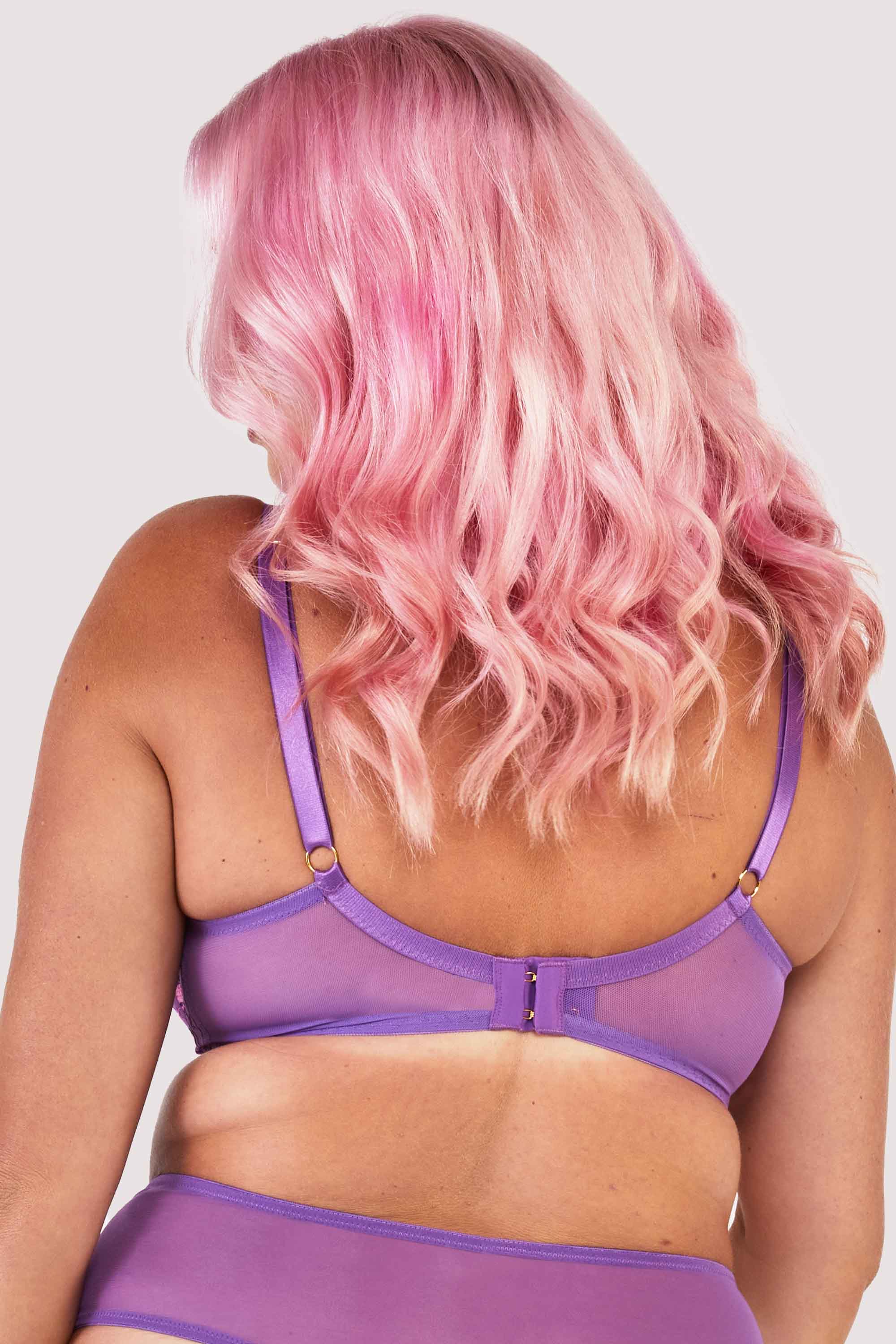 Back view of a mesh purple bra embroidered with a pink and purple floral design, with satin caging over the bust.