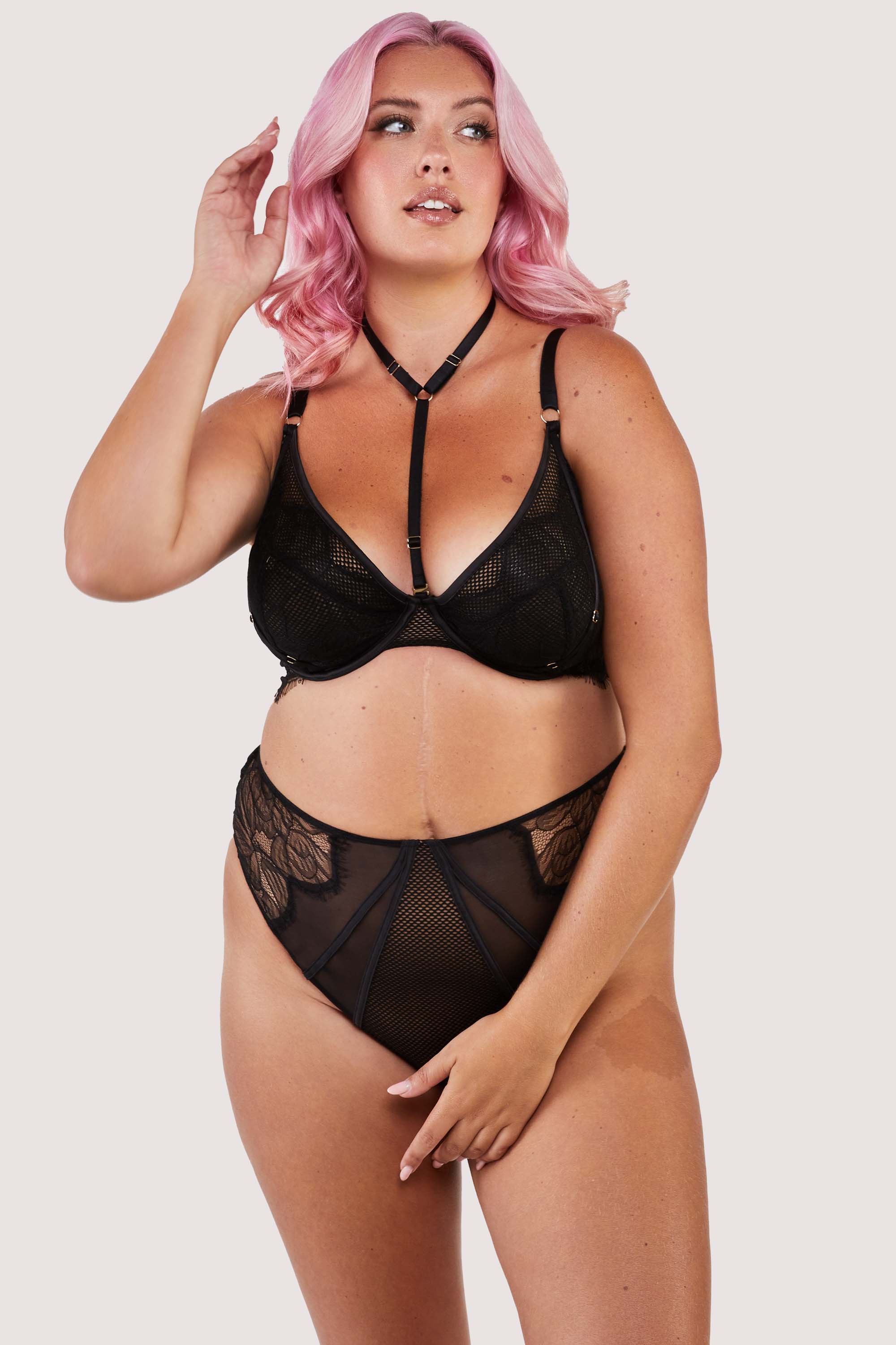 Black panelled mesh and lace crotchless thong with lace detailing, seen with a harness bra