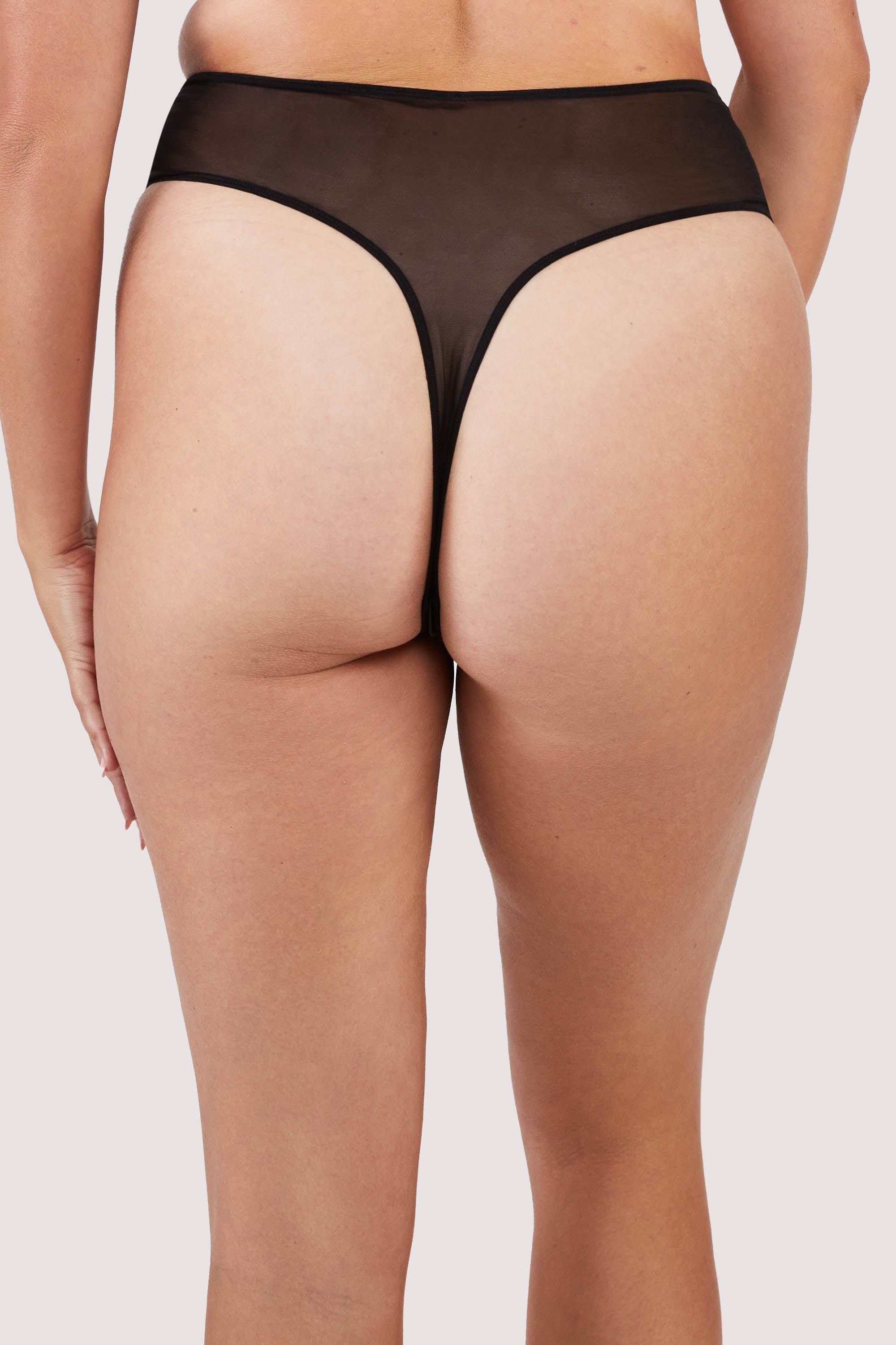 Back view of a black panelled mesh and lace crotchless thong with lace detailing.