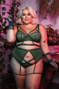 Green satin harness style brazilian brief, seen with a matching suspender and bra.