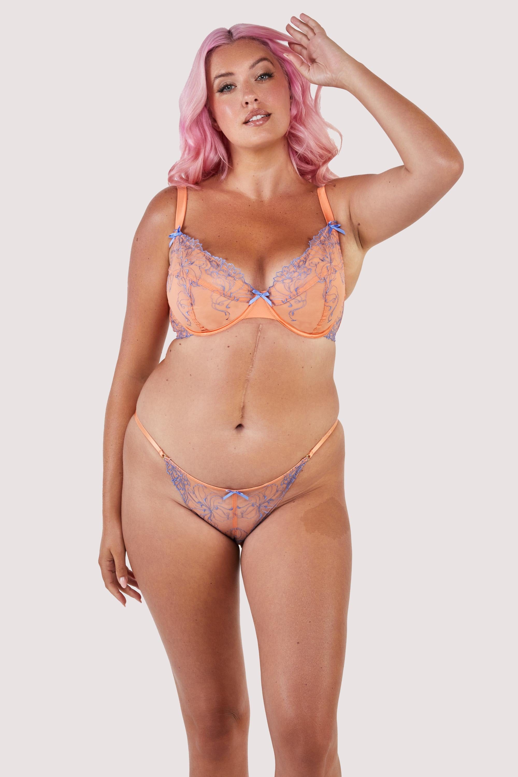 Mesh and lace orange bra and brief set with lilac/blue lace accents and bows.