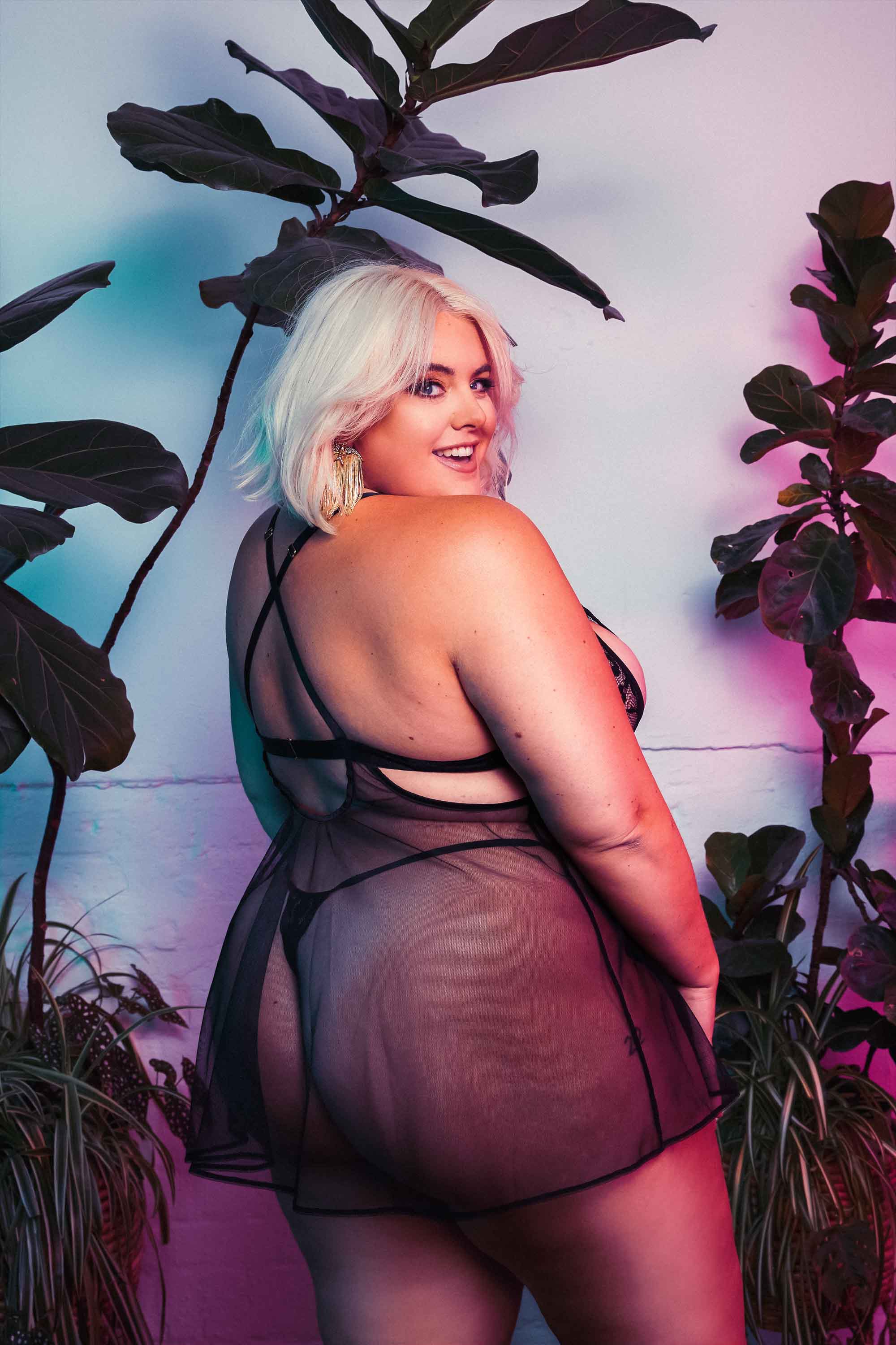 Black babydoll dress with lace and peephole cutouts on the bust and a flowing mesh dress with matching thong - seen on Felicity Hayward.