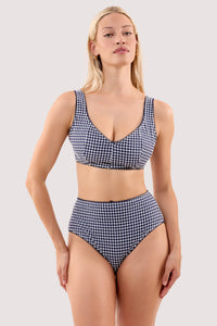 Model wears a joanna navy gingham seersucker crop bikini top with a matching high leg bikini brief.