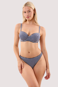 Model wears a Joanna navy gingham seersucker underwired balcony bikini top with a matching high waist brief.