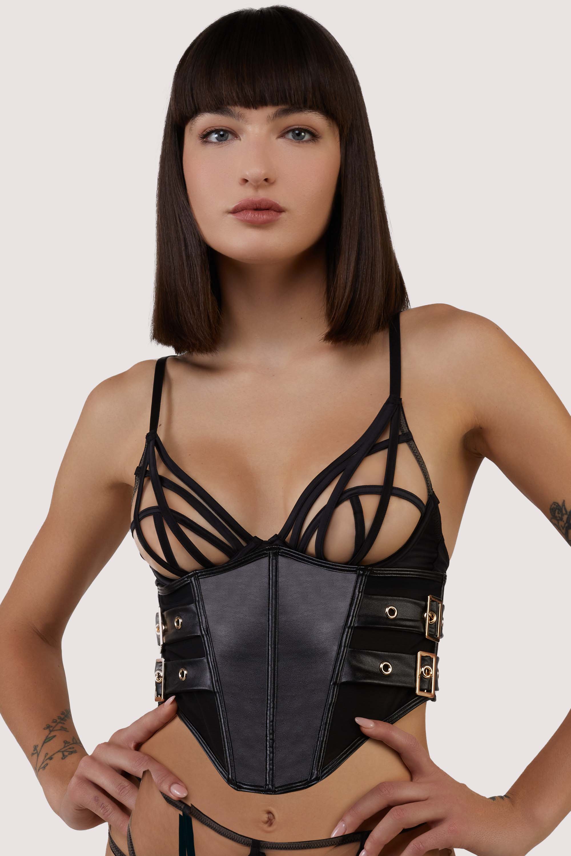 model wears black underbust corset with belt straps