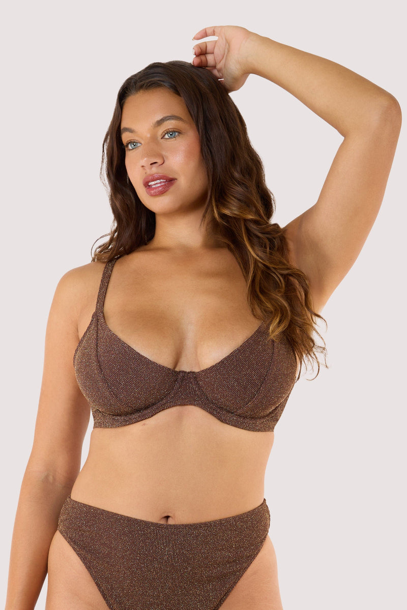 Model wearing shimmering bronze bikini with underwired bra and matching high-waist bottoms.