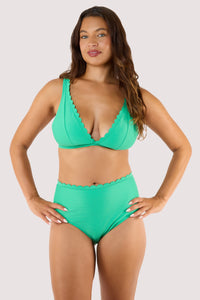 Model Wearing a jade green bikini top paired with high-waisted scalloped bottoms, embodying a playful retro swimwear style.