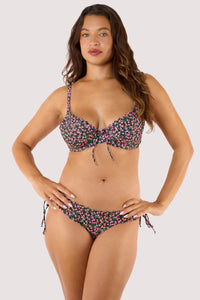 Model wearing Black Ditsy Scallop Brief bikini bottoms featuring ditsy floral print, scalloped edging, and tie sides