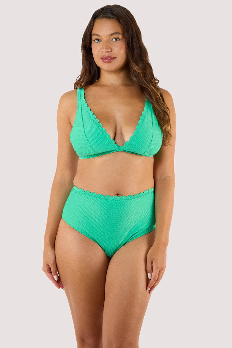 Model Wearing a green bikini top with a high-apex plunge and scalloped edges, designed for summer styling with adjustable straps.