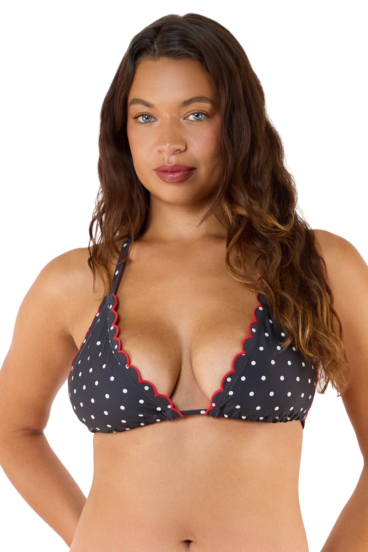 Model Wearing a black polka dot bikini top with scalloped edges and red trim, showcasing a classic triangle design.