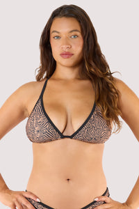 Model wearing a tiger print triangle bikini top with black trim and halterneck straps.