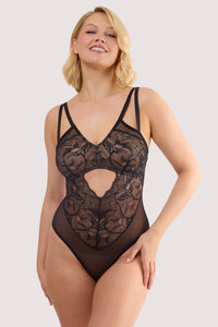 Model wears a ariella black graphic lace body with sheer mesh with graphic lace overlay featuring plunge neckline and high-leg cut.