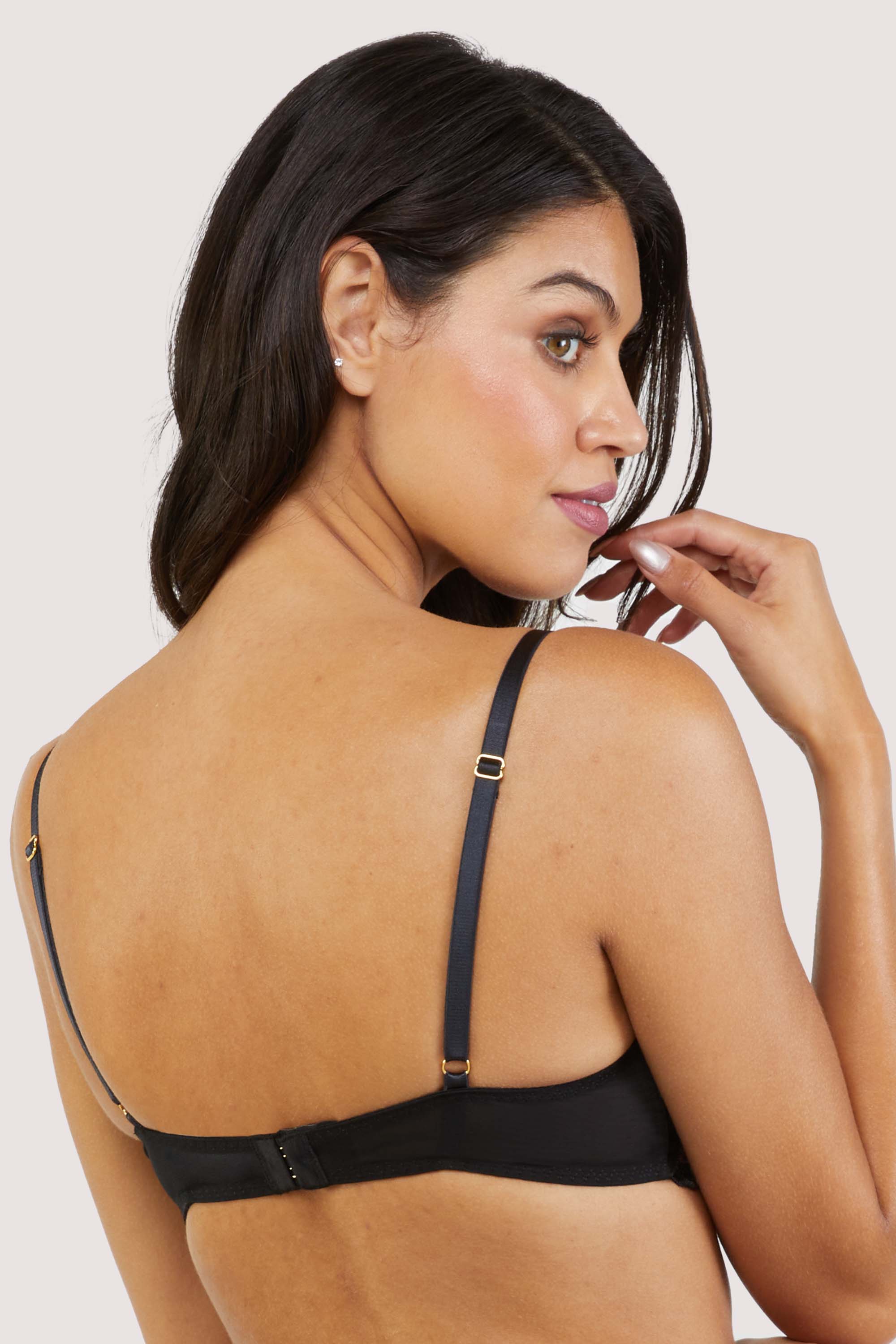 Back view of a Black Plunge Bra with delicate black and pale pink floral embroidery and underwired satin padded cups.