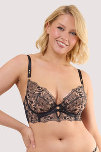 Model wears a cindy black floral embroidery longline bra featuring black mesh with floral embroidery and scalloped lace trim and satin straps.