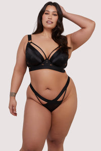 model wears black satin bra and thong lingerie set