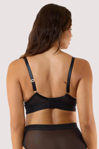 Model shows back of black sheer plunge bra with  adjustable straps hook and eye fastening longline underband