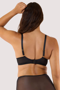 Model showing back of a black plunge bra featuring octopus embroidery and gold hardware, highlighting its elegant design.