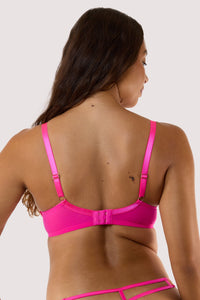model showing Back of the neon pink plunge Bra, the adjustable straps, mesh band, and hook-and-eye closure