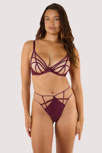 Model wears a wine plunge bra featuring a satin caged, strap detailing, and full mesh cups with underwired, with a matching wine high waist brief.