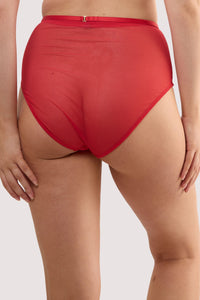 Model shows the back of a ruby red crossover high waist brief.