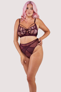 Harness style brief with mesh overlay and visible gold hardware in a deep wine red/purple, worn with a matching bra.