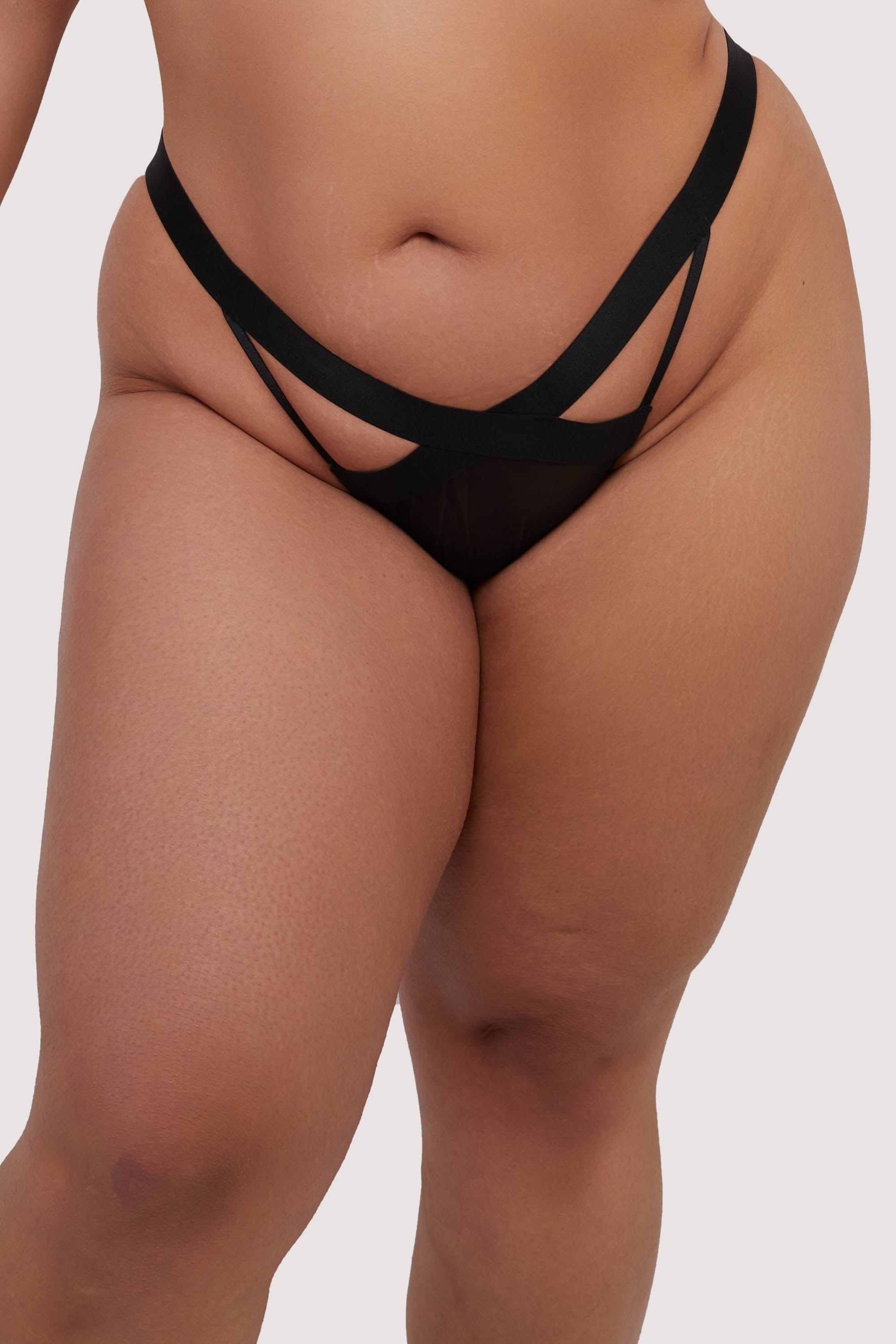 model wears black elastic and mesh brief