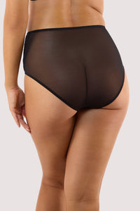 Model shows back of black lace high waisted Brief with sheer mesh back full brief style