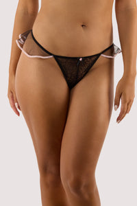 model wears black ribbon slot lace thong with sheer lace back and ribbon trim