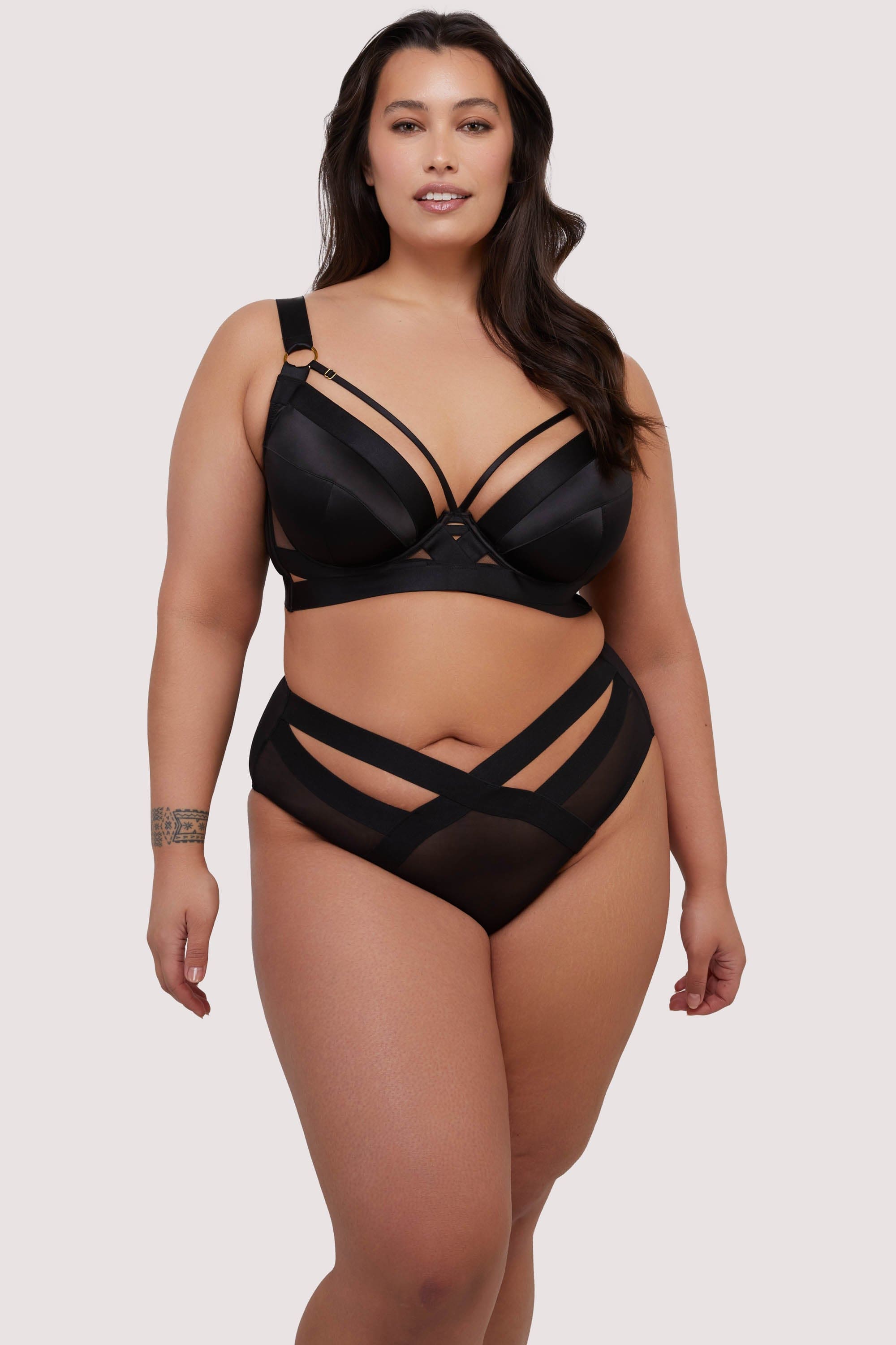 model wears black bra and high waisted elastic and mesh briefs