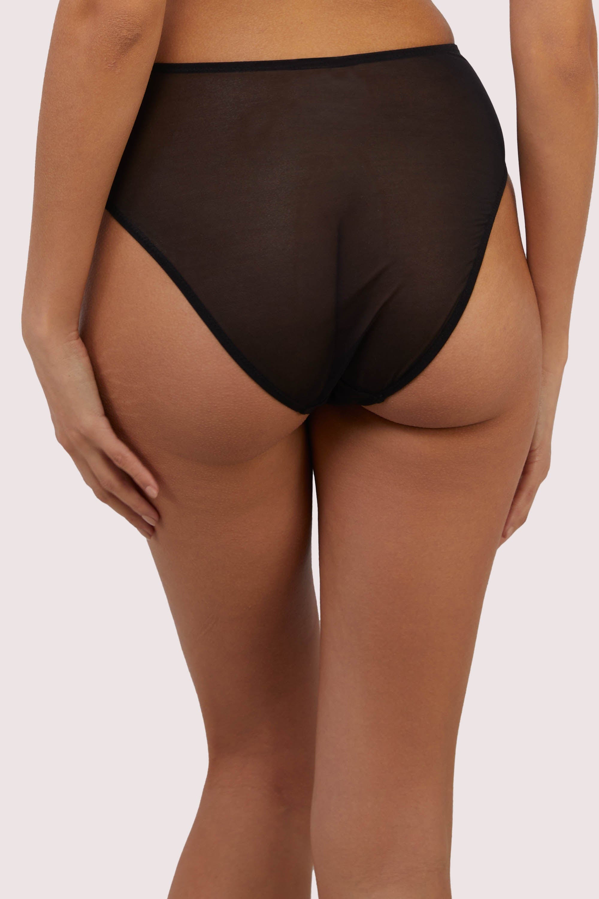 model shows us the behind of the black mesh high waisted brief