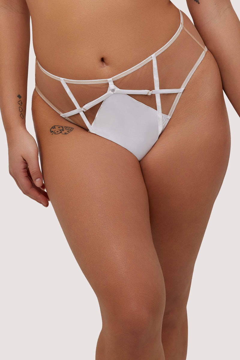 Model wears white strap detail high-waist brief