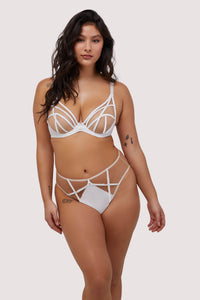 Model wears sexy white strap detail plunge bra and brief set