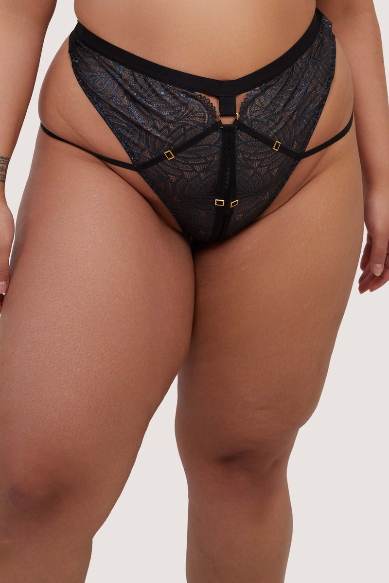 model wears black wet look lace high waist thong with straps